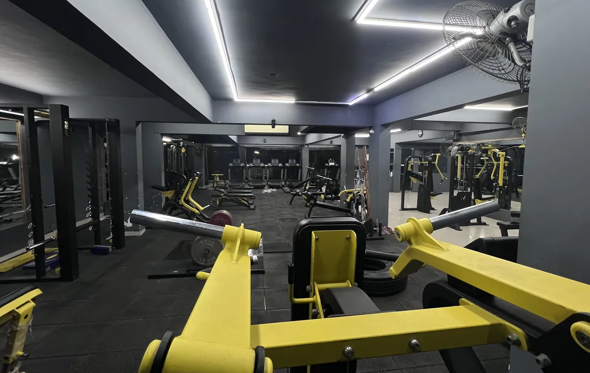 Main training floor at Transformation HQ with free-weight equipment