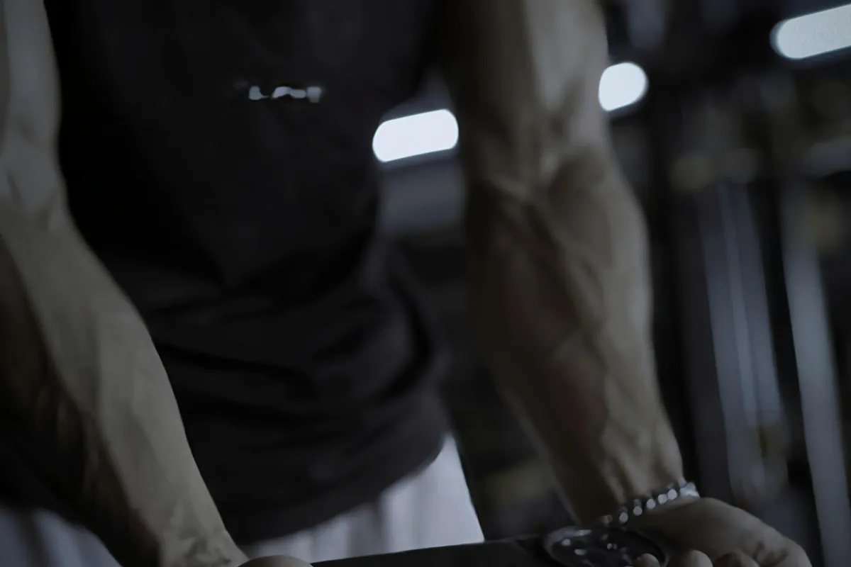 Close-up of a loaded barbell being held mid-set